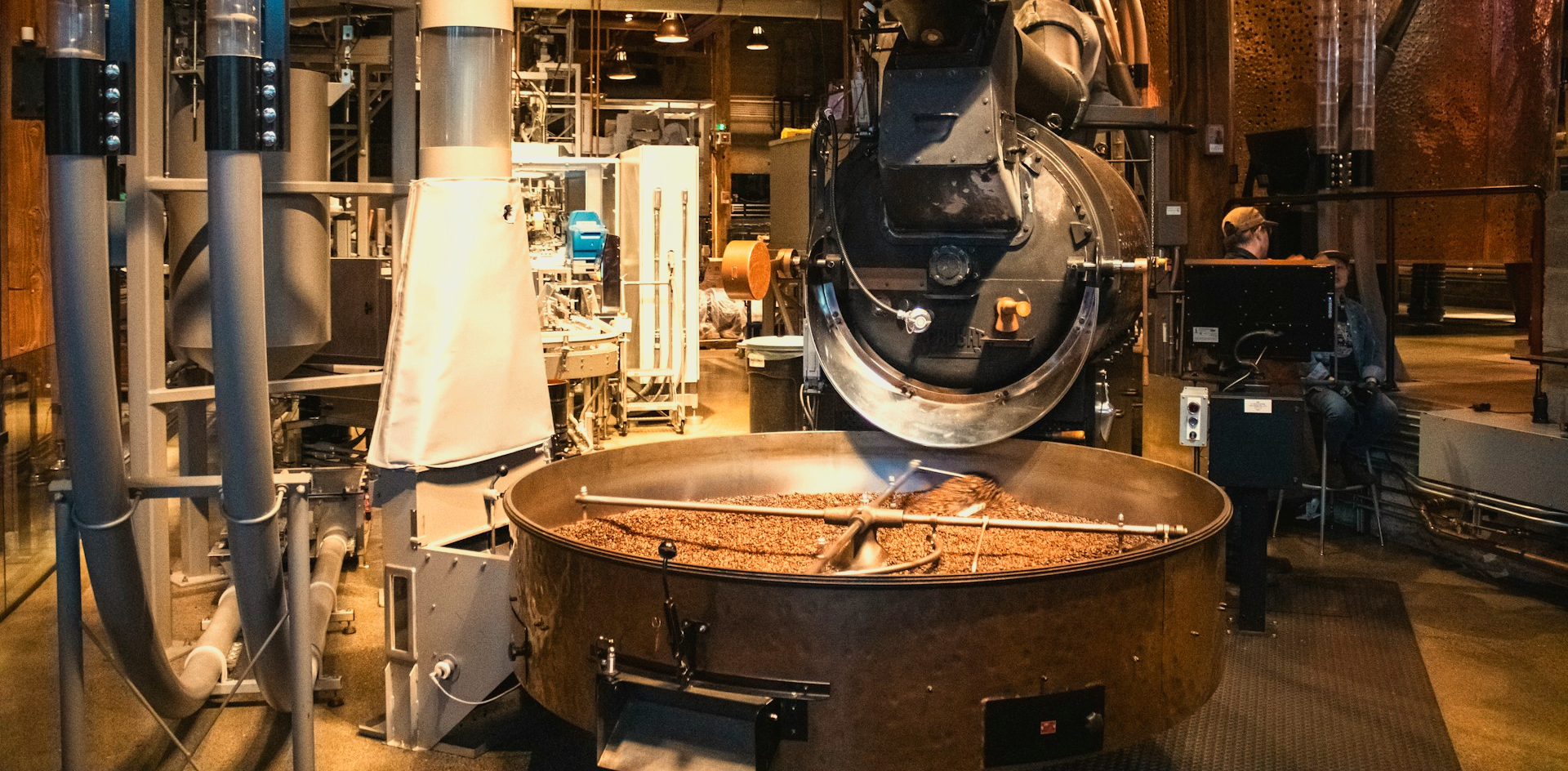 Coffee beans roasting in an industrial machine.